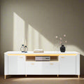 Modern white entertainment console with decorative items on a white background