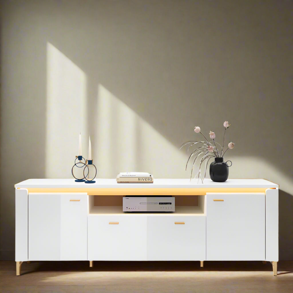 Modern white entertainment console with decorative items on a white background